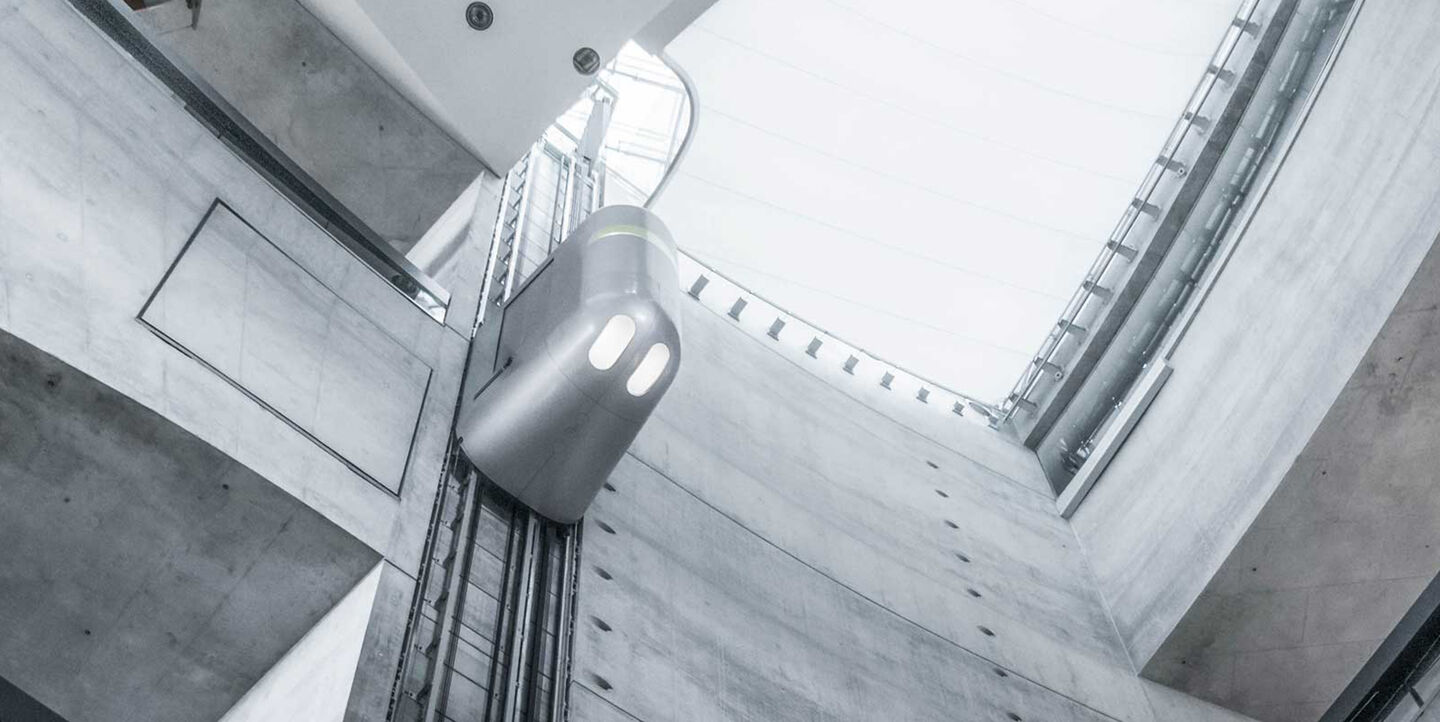 Futuristic elevator within modern, grey colored, futuristic building